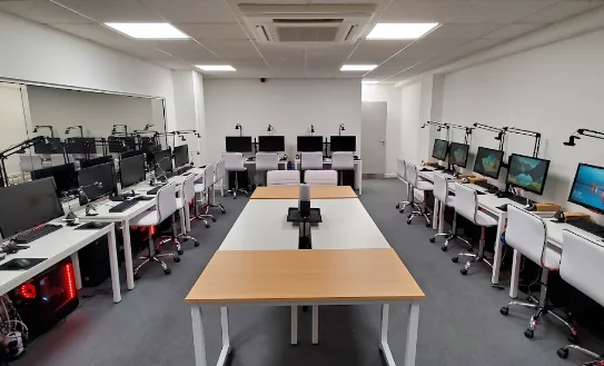 A fully kitted-out gaming research lab with multiple monitor and peripheral setups